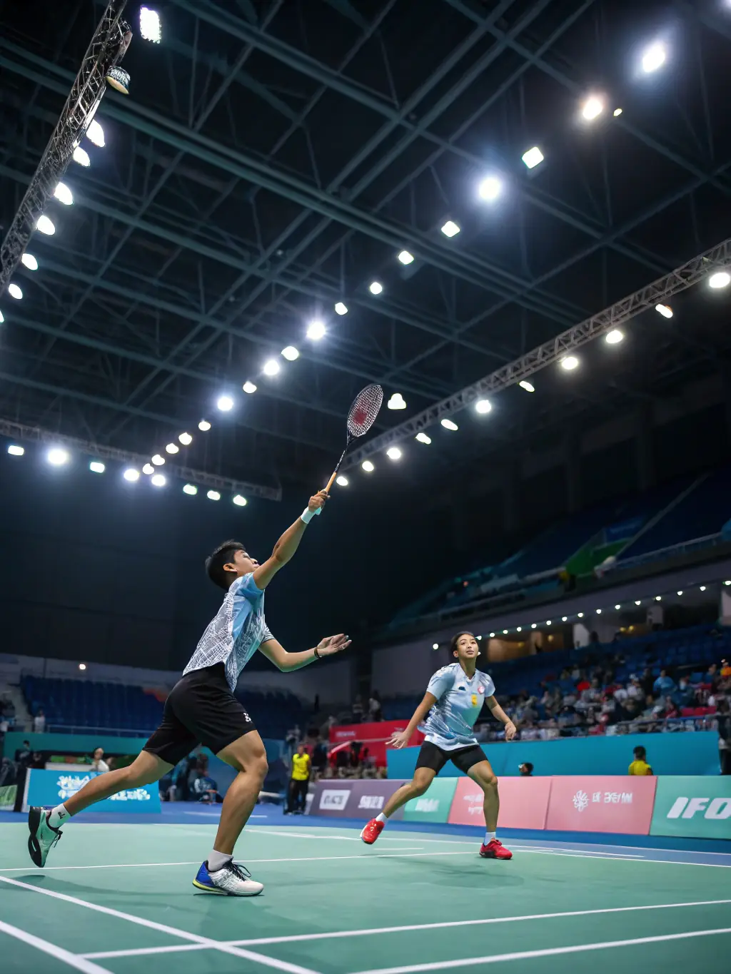 A dynamic shot of adult players competing in a friendly badminton match at LE VOLANT DE L'ALAGNON, highlighting the competitive spirit and camaraderie.