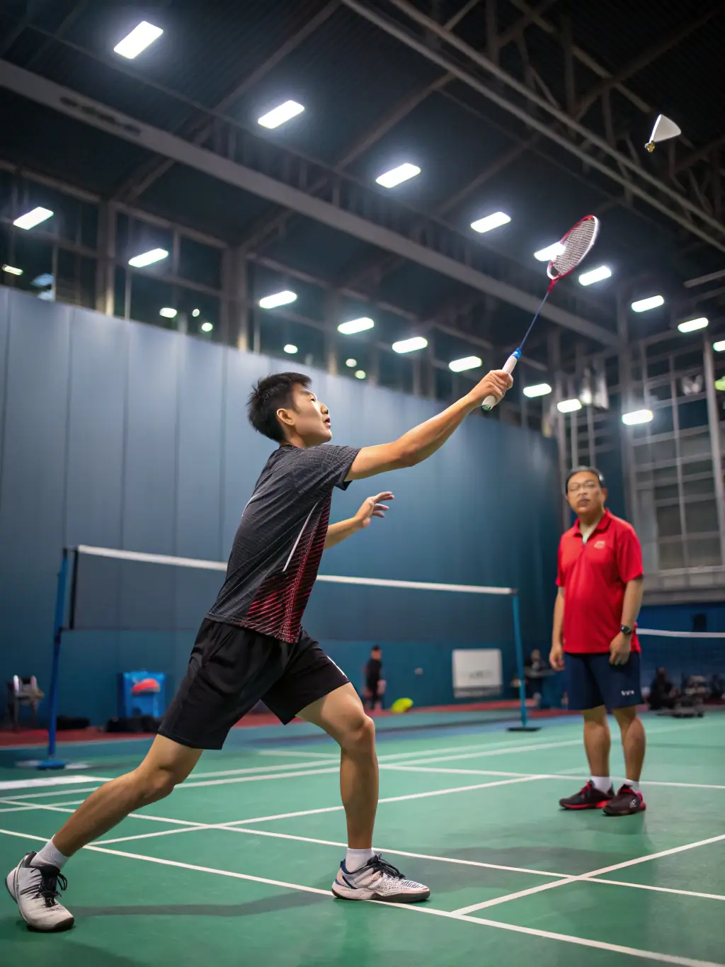 A dynamic shot of a badminton player leaping to smash the shuttlecock during a competitive match, showcasing the athleticism and excitement of the sport.